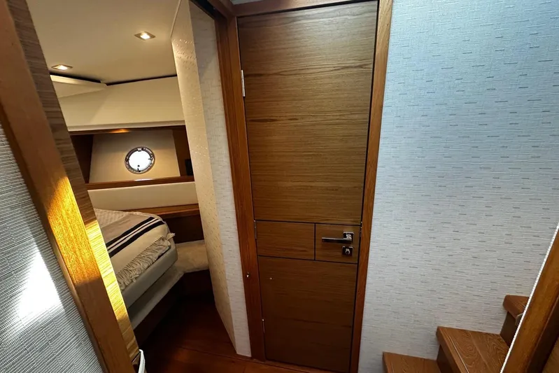  Yacht Photos Pics Interior of 2022 Tiara Yachts C39 Coupe, featuring a cozy cabin with wooden finishes.