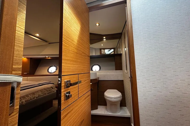 Yacht Photos Pics 2022 Tiara Yachts C39 Coupe interior with wooden finishes and modern bathroom.