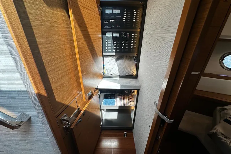  Yacht Photos Pics 2022 Tiara Yachts C39 Coupe interior with control panel and storage area.