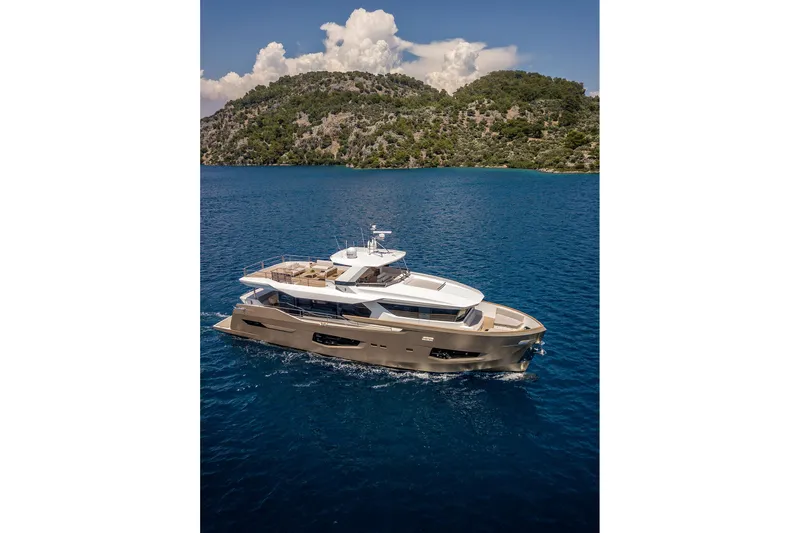 Numarine 26xp Yacht Photos Pics Luxurious 2025 Numarine 26XP yacht cruising in clear blue waters near a lush island.