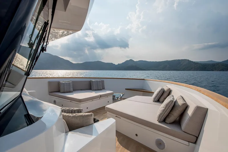 Numarine 26xp Yacht Photos Pics Luxurious 2025 Numarine 26XP yacht deck with elegant seating, overlooking serene ocean and mountains.