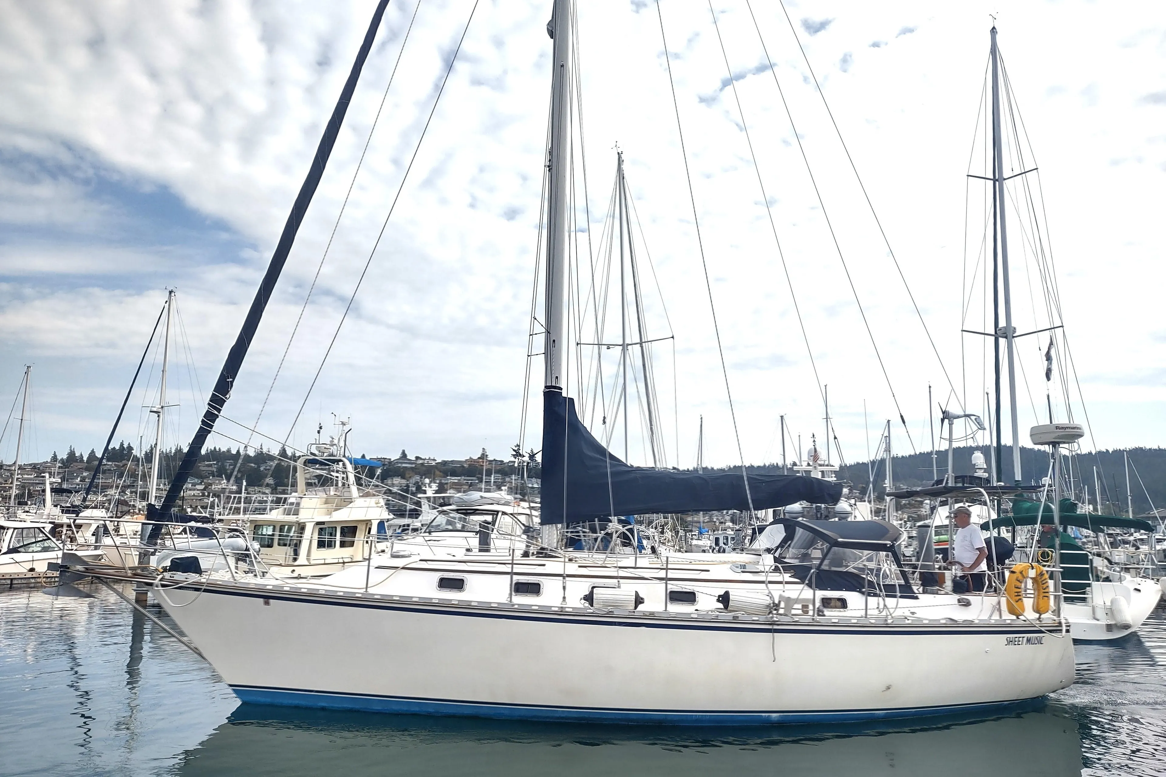 1989 Caliber 38 sailboat docked in a marina with other boats.