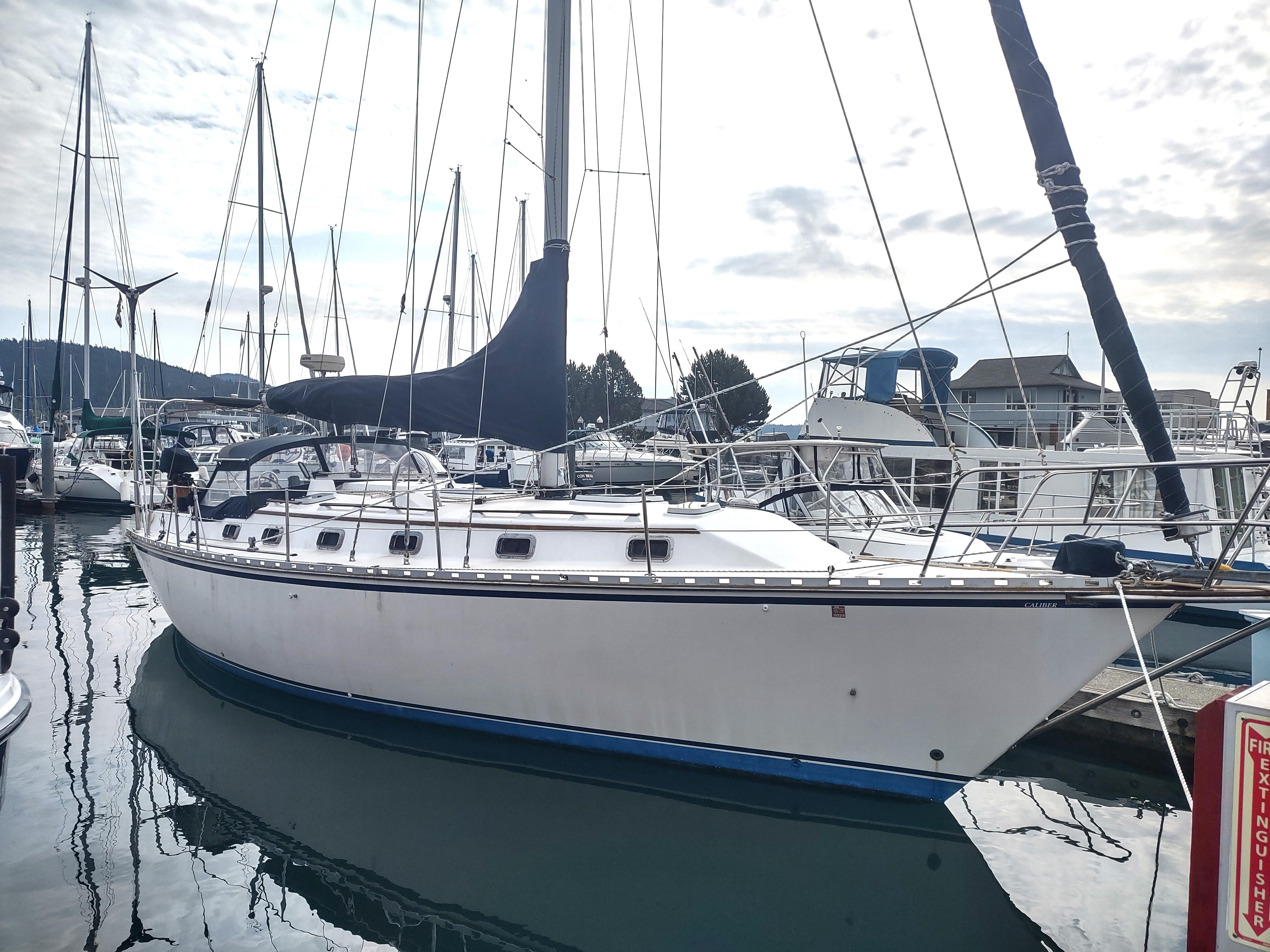 1989 Caliber 38 sailboat docked at a marina.