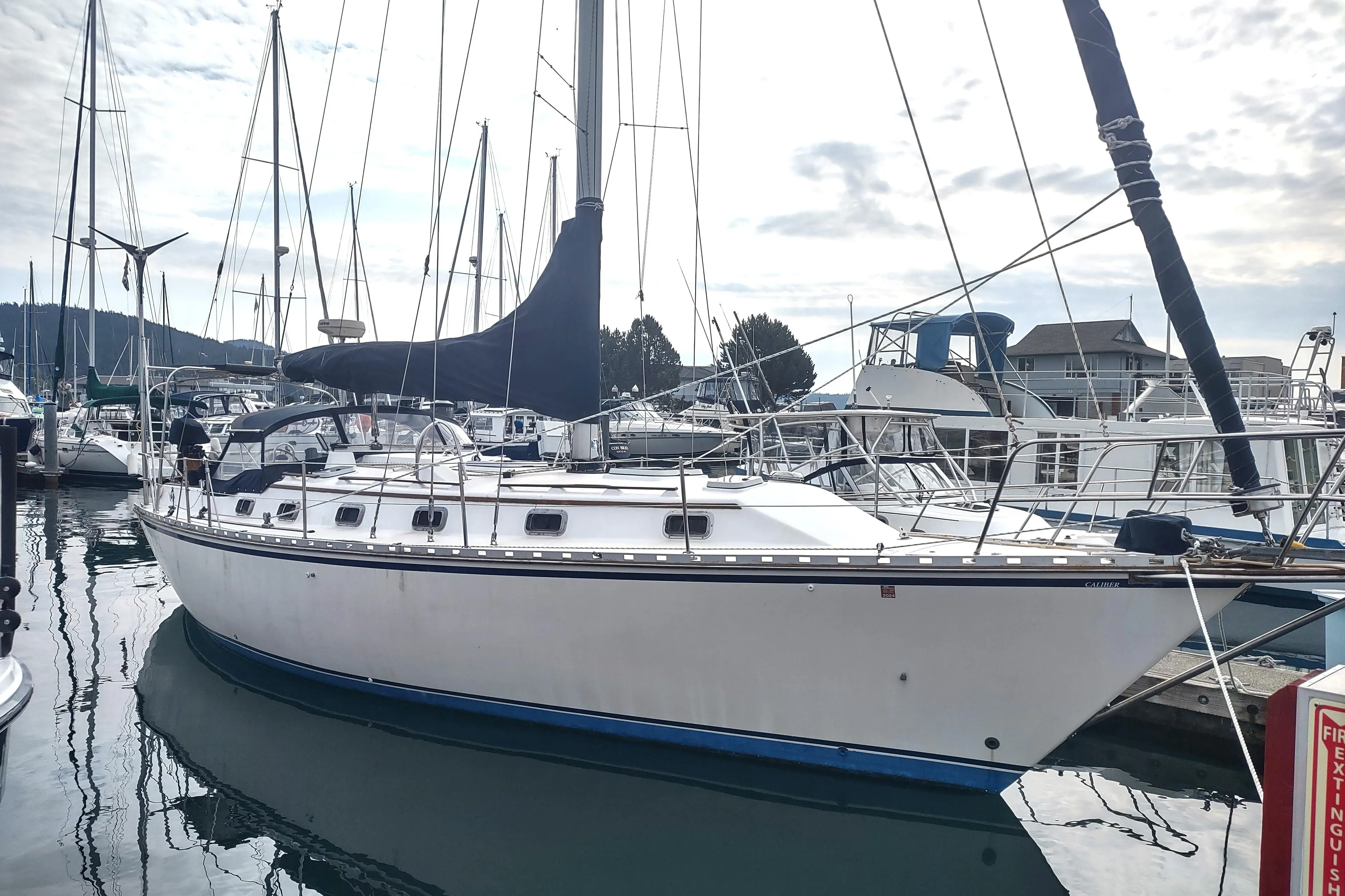 1989 Caliber 38 sailboat docked at a marina.
