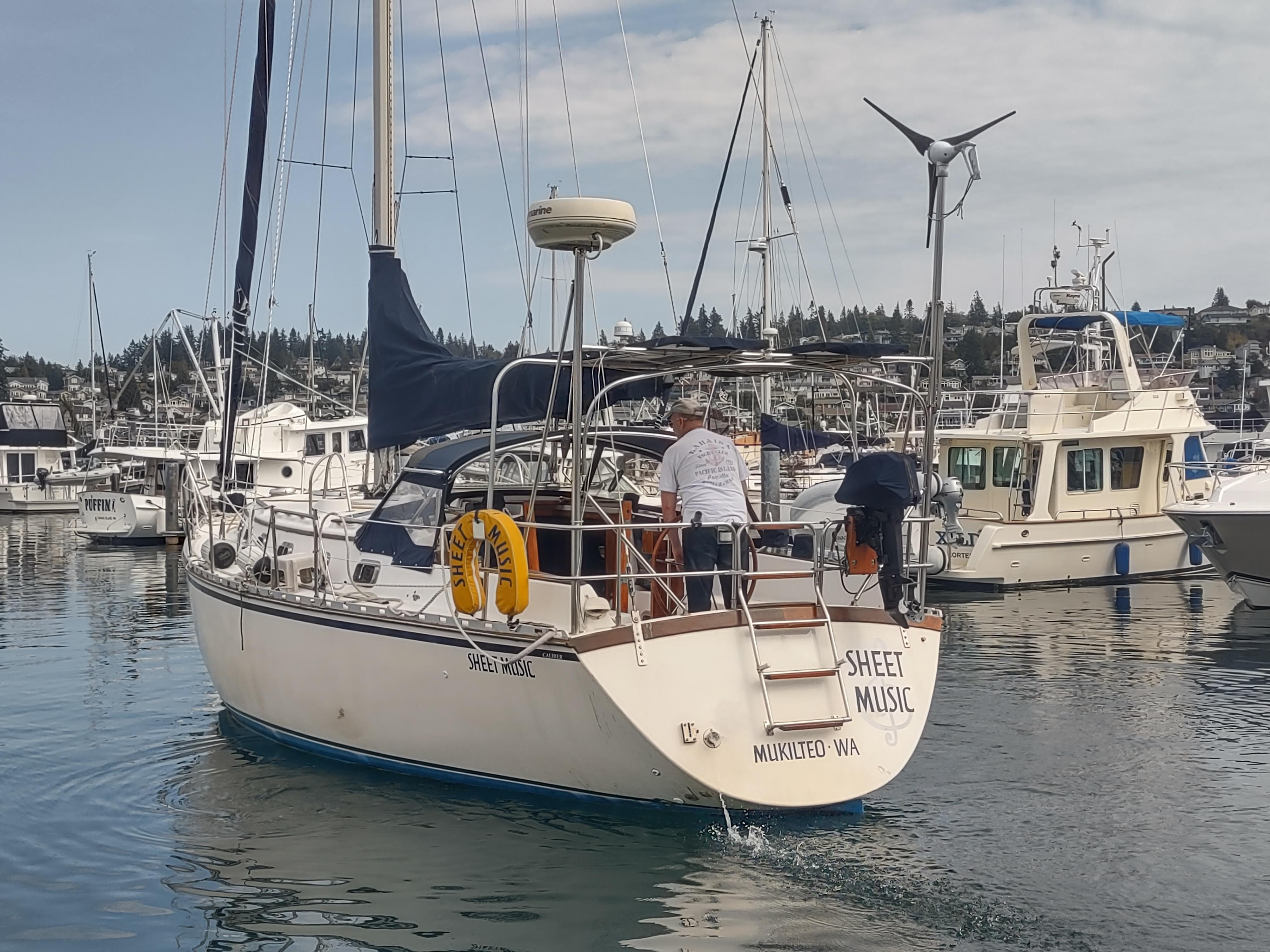 Caliber 38 sailboat, 1989 model, named Sheet Music, docked in a marina.