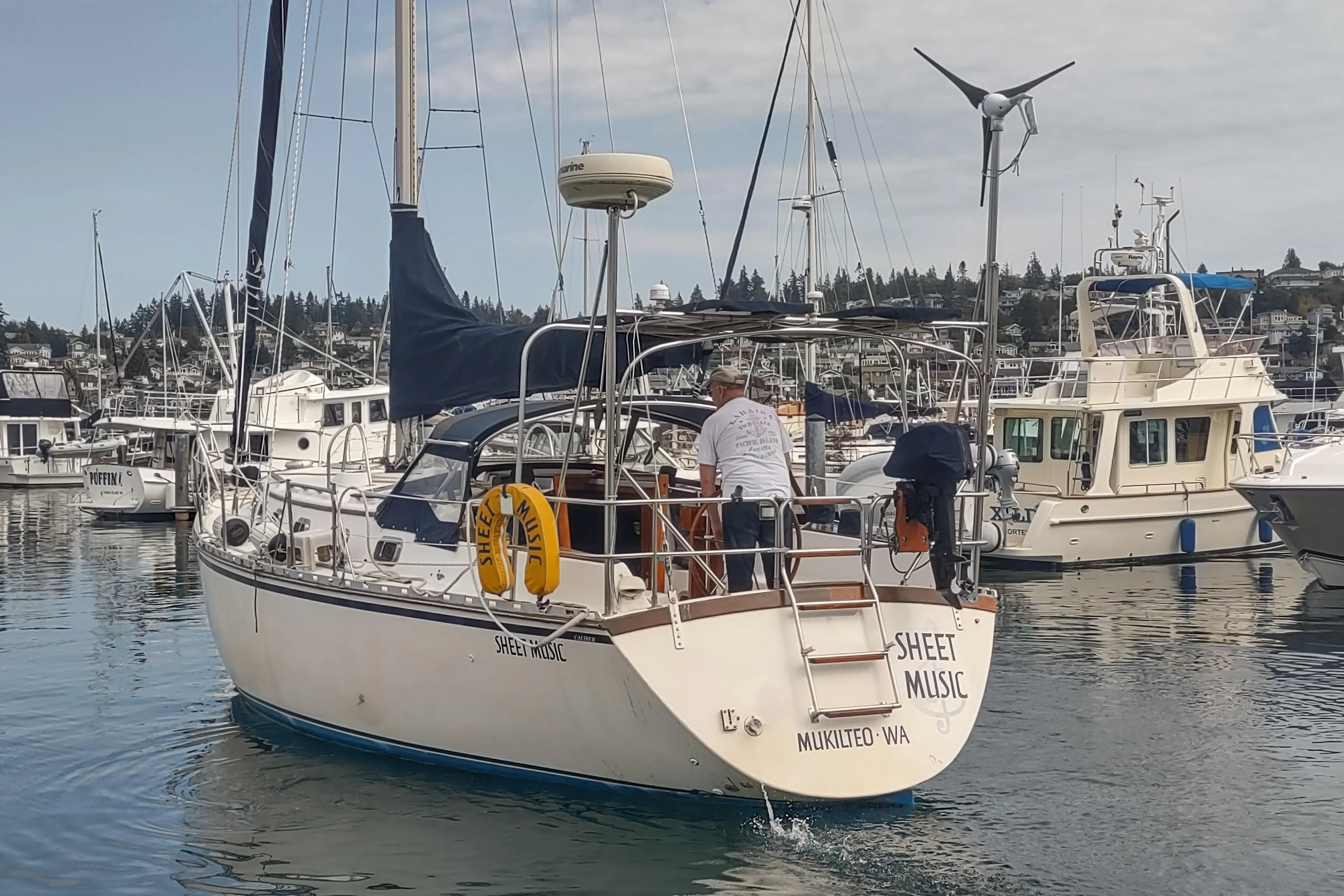 Caliber 38 sailboat, 1989 model, named Sheet Music, docked in a marina.