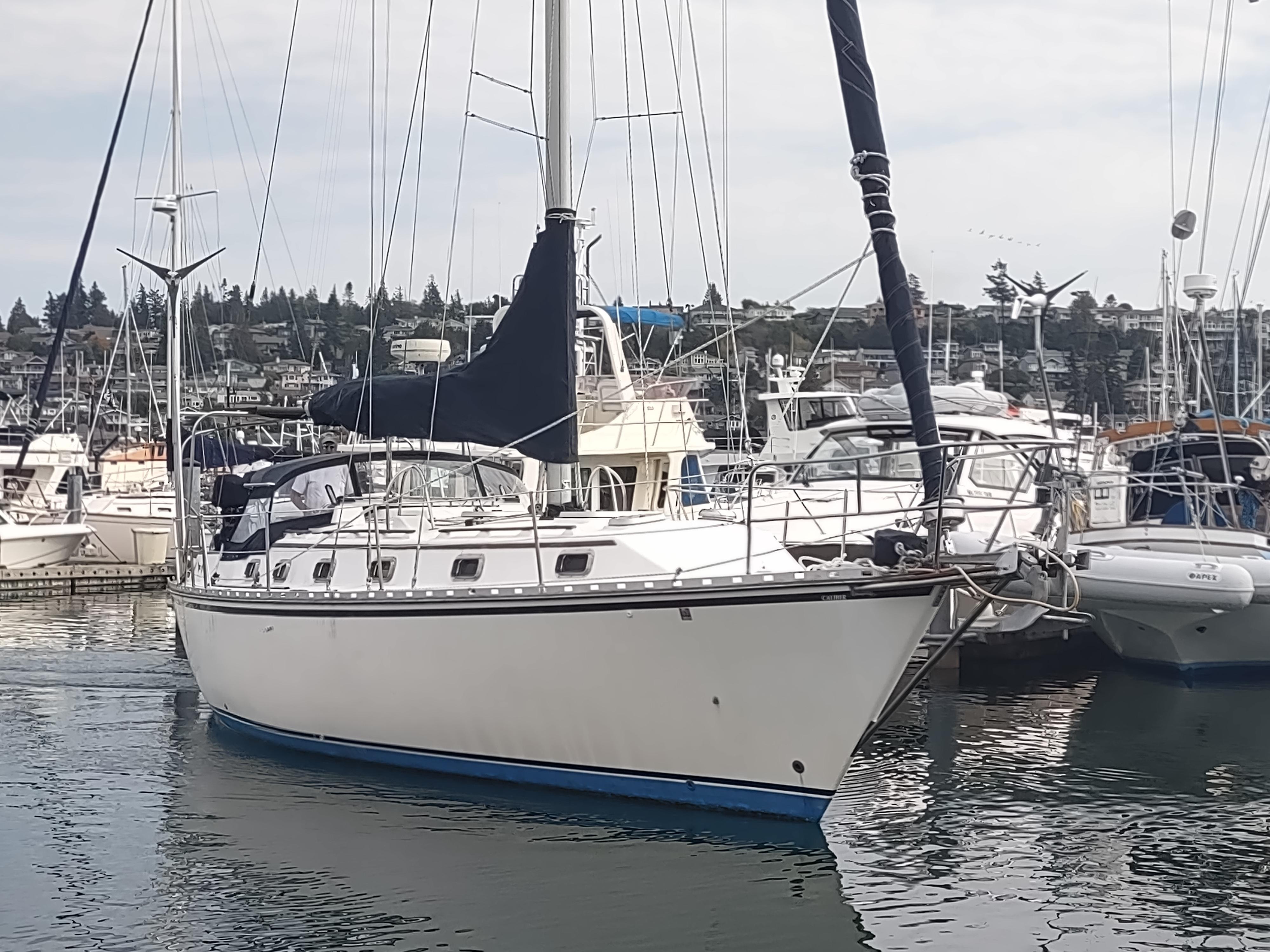 1989 Caliber 38 sailboat docked in a marina.