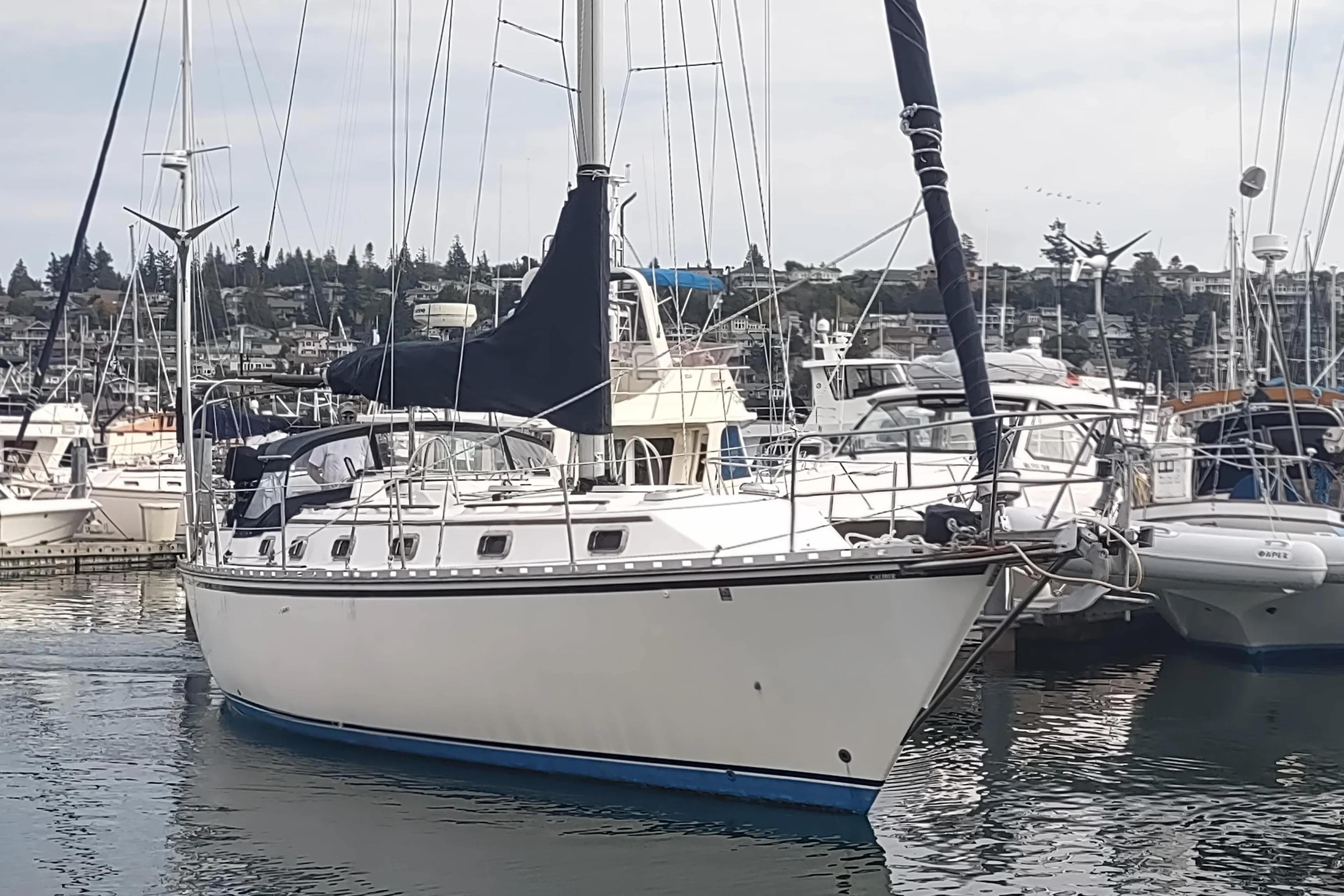 1989 Caliber 38 sailboat docked in a marina.