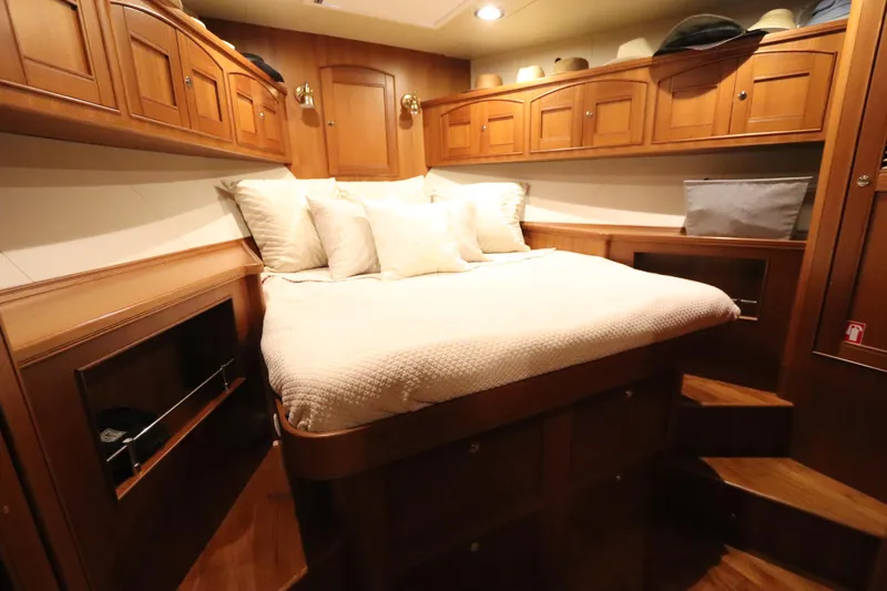 Mi Cielo Yacht Photos Pics Luxurious cabin interior of 2017 Marlow Explorer 49E yacht with cozy bed and wooden cabinetry.