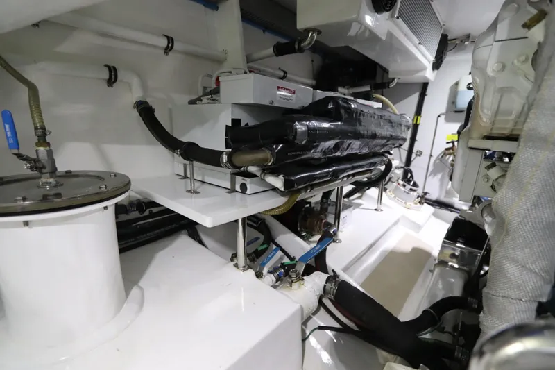 Mi Cielo Yacht Photos Pics Engine room of 2017 Marlow Explorer 49E yacht, showcasing mechanical components and piping.