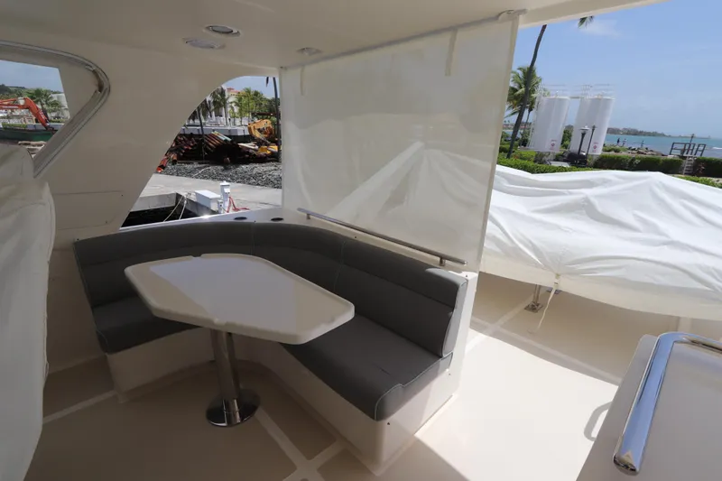 Mi Cielo Yacht Photos Pics 2017 Marlow Explorer 49E yacht with outdoor seating and table, docked near water.