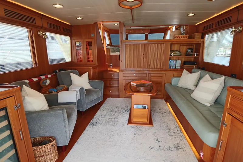 Mi Cielo Yacht Photos Pics Luxurious interior of 2017 Marlow Explorer 49E yacht with cozy seating and elegant wood finishes.