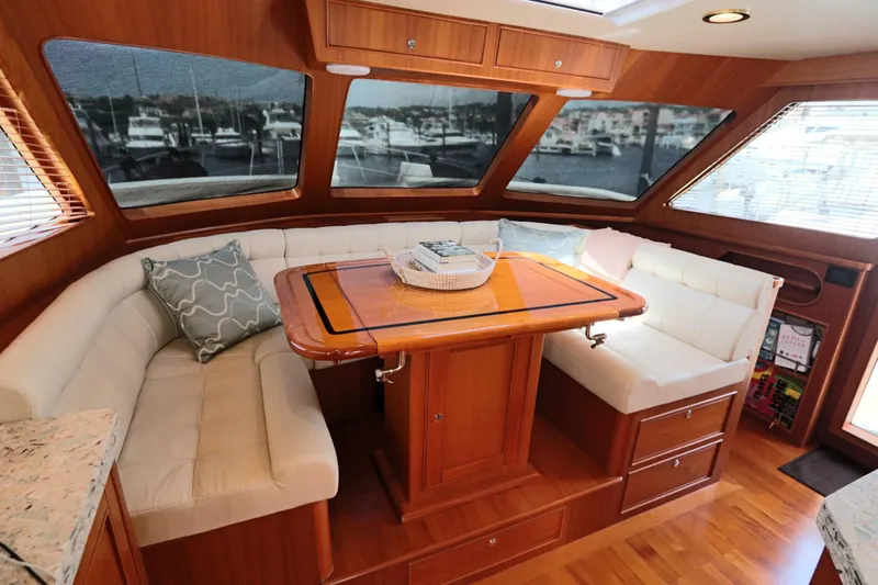 Mi Cielo Yacht Photos Pics Luxurious interior of 2017 Marlow Explorer 49E yacht with elegant seating and wooden table.