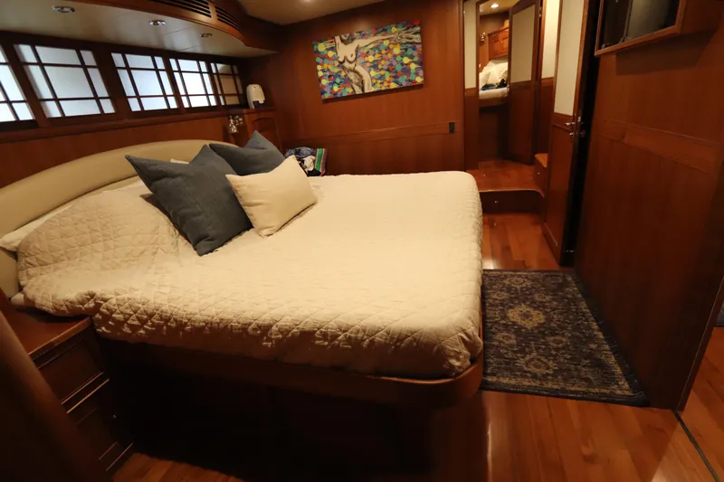 Mi Cielo Yacht Photos Pics Luxurious cabin interior of 2017 Marlow Explorer 49E yacht with cozy bed and elegant decor.