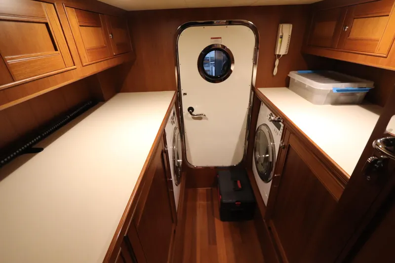 Mi Cielo Yacht Photos Pics Laundry room in 2017 Marlow Explorer 49E yacht with wooden cabinets and appliances.