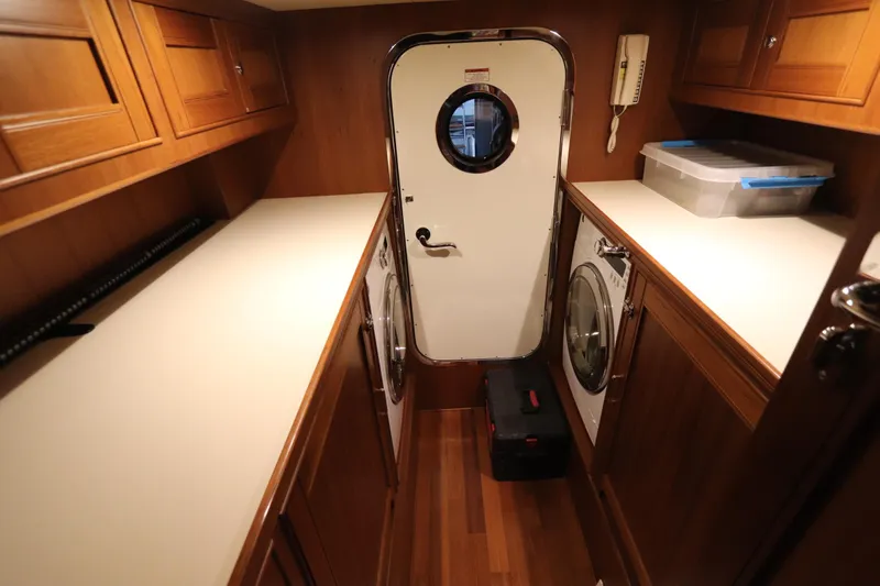 Mi Cielo Yacht Photos Pics Laundry room in 2017 Marlow Explorer 49E yacht with washer, dryer, and storage cabinets.
