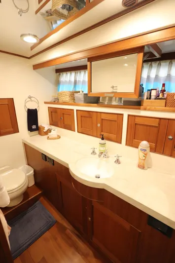 Mi Cielo Yacht Photos Pics 2017 Marlow Explorer 49E yacht bathroom with wooden cabinets and modern fixtures.