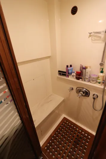 Mi Cielo Yacht Photos Pics Shower area in 2017 Marlow Explorer 49E yacht with toiletries and wooden floor mat.