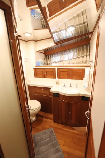 Mi Cielo Yacht Photos Pics Luxurious bathroom in 2017 Marlow Explorer 49E yacht with wooden cabinetry and modern fixtures.