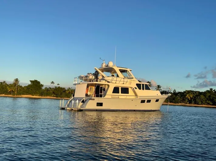 Mi Cielo Yacht Photos Pics 2017 Marlow Explorer 49E yacht on tranquil water near tropical shoreline.