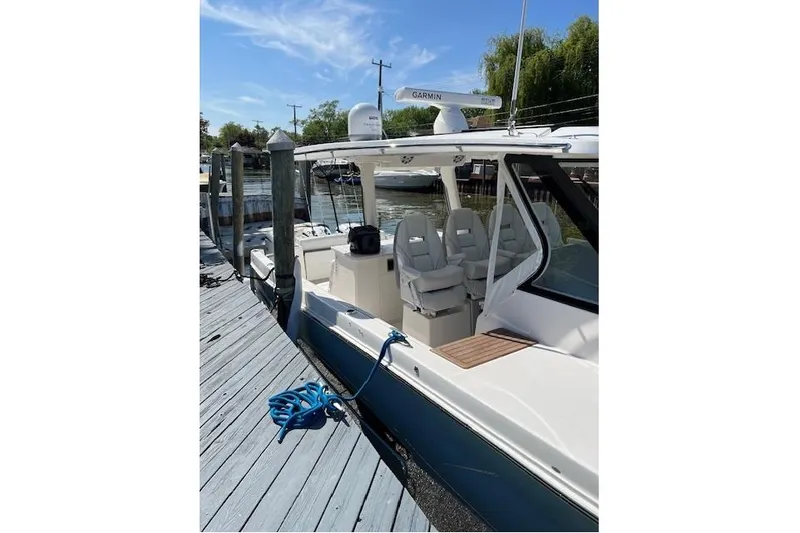  Yacht Photos Pics 2023 Regal 38 SAV boat docked, featuring sleek design and modern amenities.