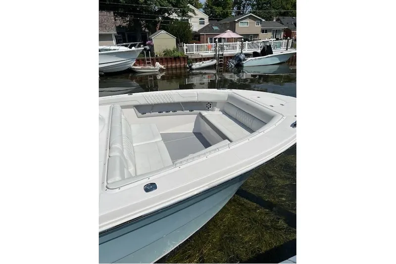  Yacht Photos Pics 2023 Regal 38 SAV boat docked, featuring spacious seating and sleek design.