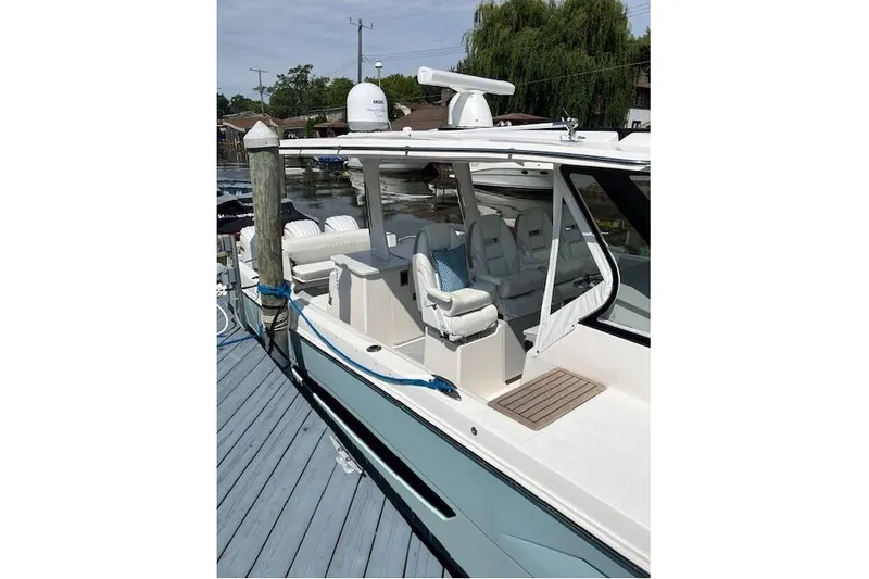  Yacht Photos Pics 2023 Regal 38 SAV boat docked, featuring sleek design and comfortable seating.