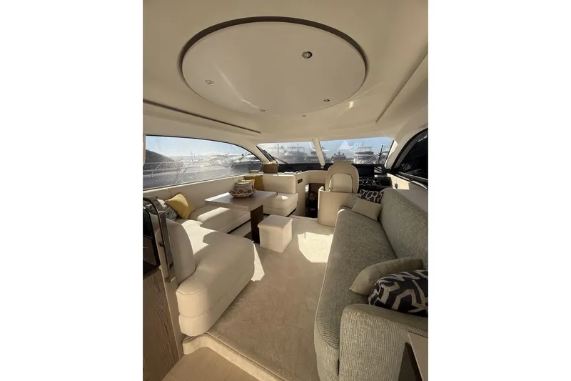  Yacht Photos Pics Luxurious interior of 2024 Azimut 53 Fly yacht with elegant seating and panoramic windows.
