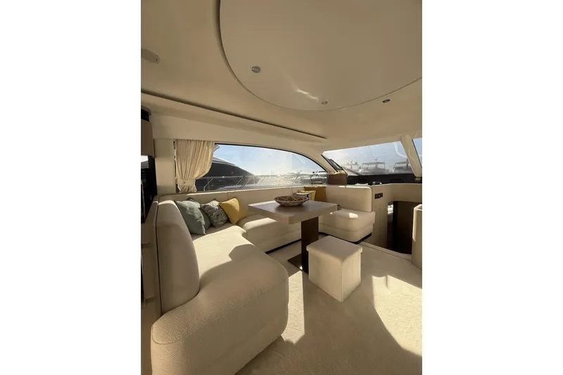  Yacht Photos Pics Luxurious interior of 2024 Azimut 53 Fly yacht with elegant seating and panoramic windows.