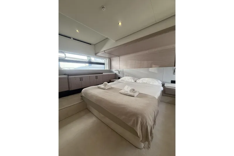  Yacht Photos Pics Luxurious bedroom interior of 2024 Azimut 53 Fly yacht, featuring elegant design and cozy bedding.
