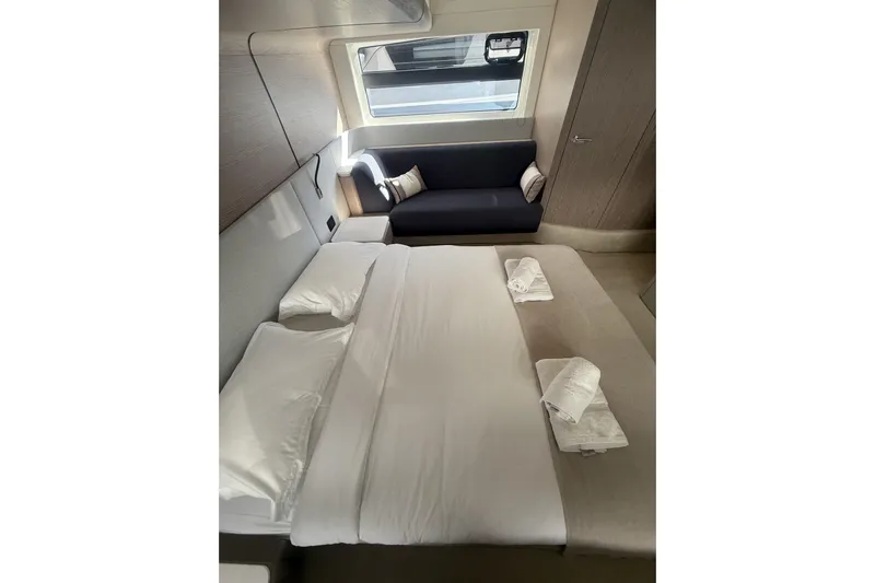  Yacht Photos Pics Luxurious bedroom interior of 2024 Azimut 53 Fly yacht with modern design and cozy seating.