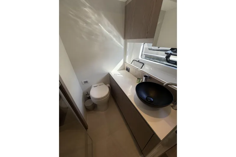  Yacht Photos Pics Luxurious bathroom in 2024 Azimut 53 Fly yacht with modern fixtures and sleek design.