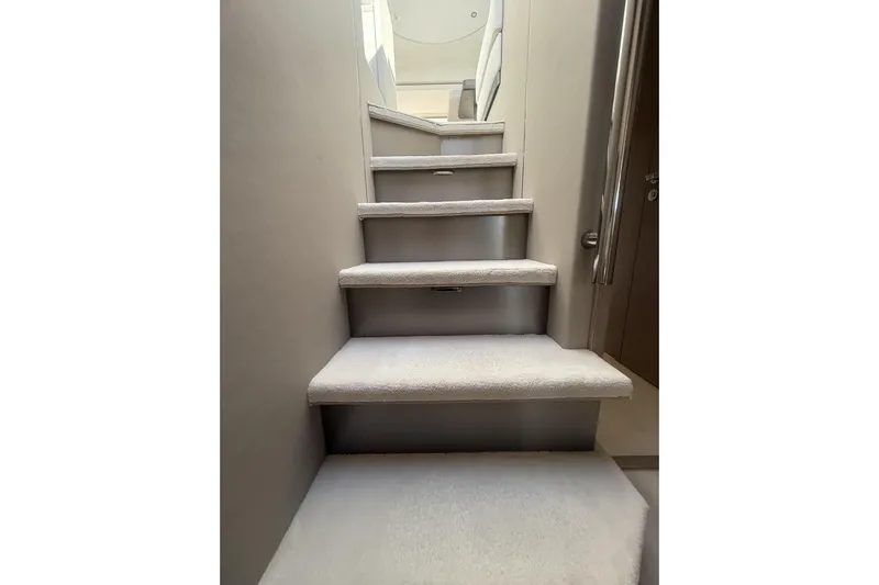  Yacht Photos Pics Staircase inside 2024 Azimut 53 Fly yacht, featuring modern design and carpeting.