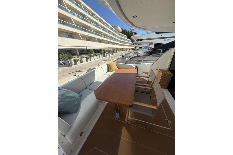  Yacht Photos Pics 2024 Azimut 53 Fly yacht with elegant outdoor seating and dining area.