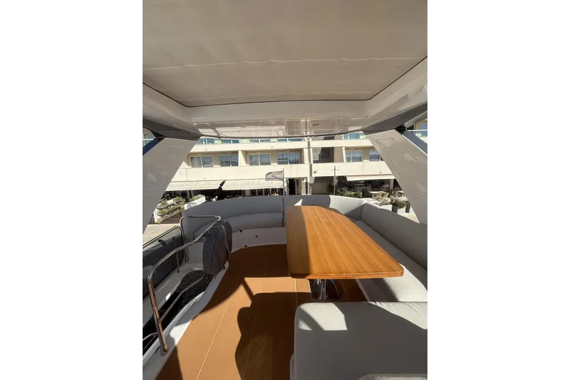  Yacht Photos Pics Luxurious interior of 2024 Azimut 53 Fly yacht with elegant wooden table.