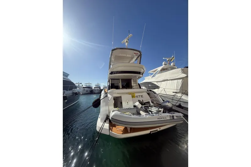  Yacht Photos Pics 2024 Azimut 53 Fly yacht docked in marina under clear blue sky.