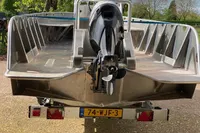 Aluminum boat with outboard motor on trailer, Evens Defender 2022 model.