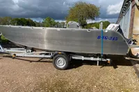 2022 Evens Defender boat on trailer, parked outdoors under cloudy sky.
