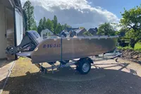 2022 Evens Defender boat on trailer, parked outdoors under a cloudy sky.
