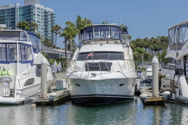 Just Joyce Yacht Photos Pics 2000 Silverton 435 yacht docked at marina with palm trees and buildings in background.
