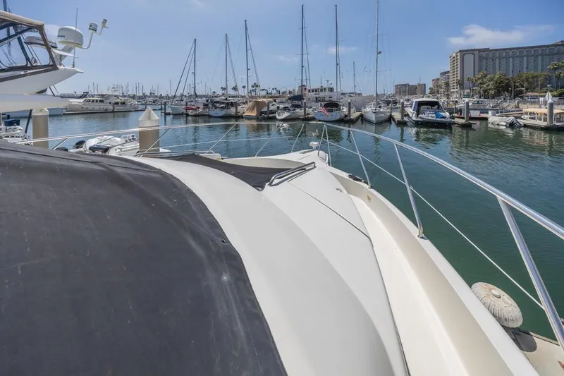 Just Joyce Yacht Photos Pics Silverton 435 yacht from 2000 docked in a marina with other boats.