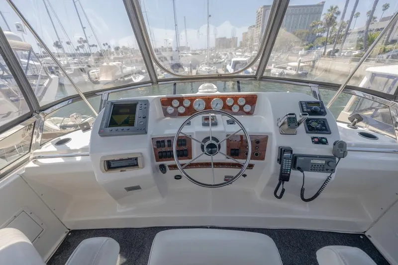 Just Joyce Yacht Photos Pics Cockpit of 2000 Silverton 435 yacht with steering wheel and navigation equipment.