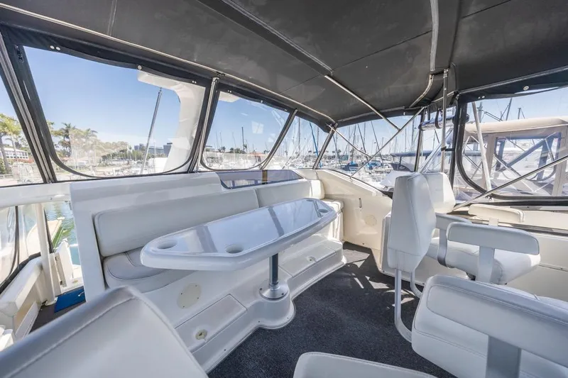 Just Joyce Yacht Photos Pics Interior view of a 2000 Silverton 435 yacht with seating and table.