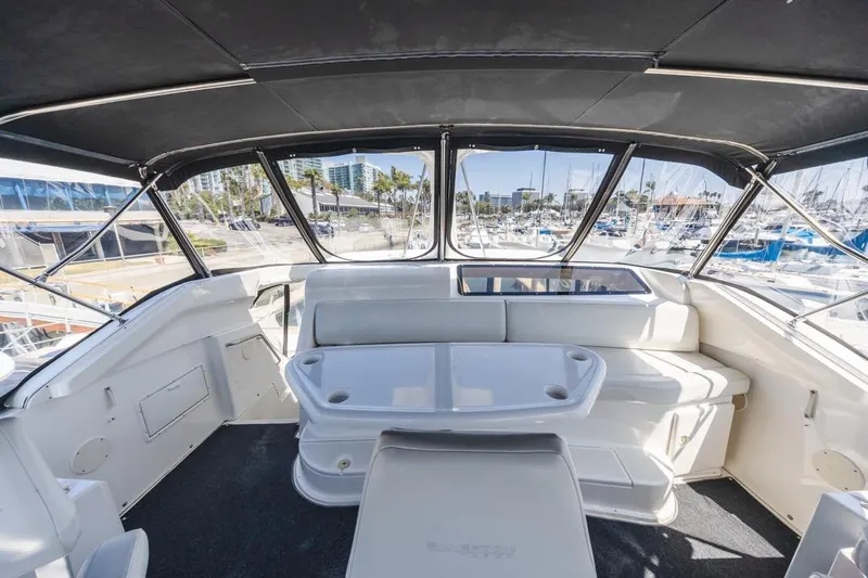 Just Joyce Yacht Photos Pics Interior view of a 2000 Silverton 435 yacht with seating and marina backdrop.