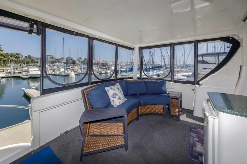 Just Joyce Yacht Photos Pics Interior of 2000 Silverton 435 yacht with blue seating, marina view.