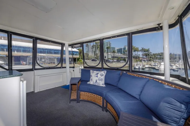 Just Joyce Yacht Photos Pics Interior of 2000 Silverton 435 yacht with blue seating and marina view.