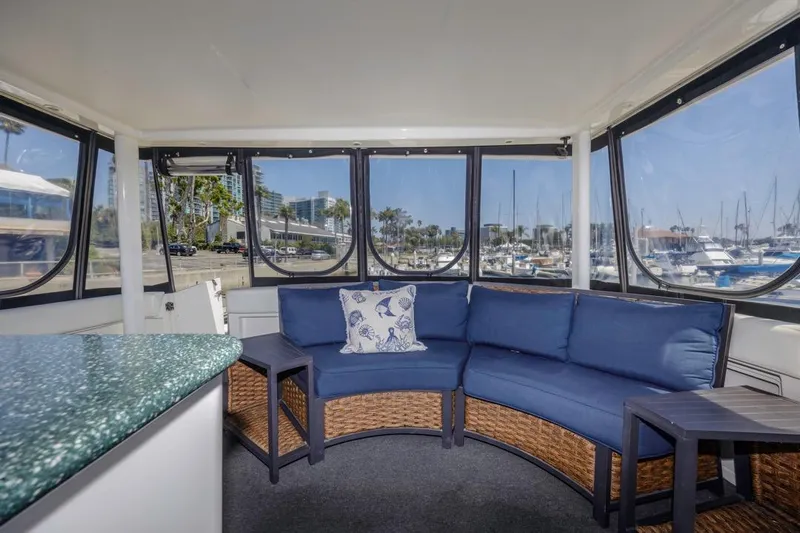 Just Joyce Yacht Photos Pics Interior of 2000 Silverton 435 yacht with blue seating and marina view.