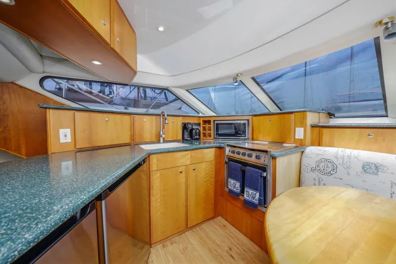 Just Joyce Yacht Photos Pics Interior of 2000 Silverton 435 yacht kitchen with wood cabinets and modern appliances.