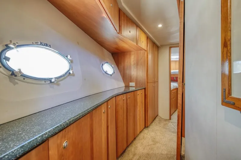 Just Joyce Yacht Photos Pics Interior of 2000 Silverton 435 yacht with wooden cabinets and porthole windows.