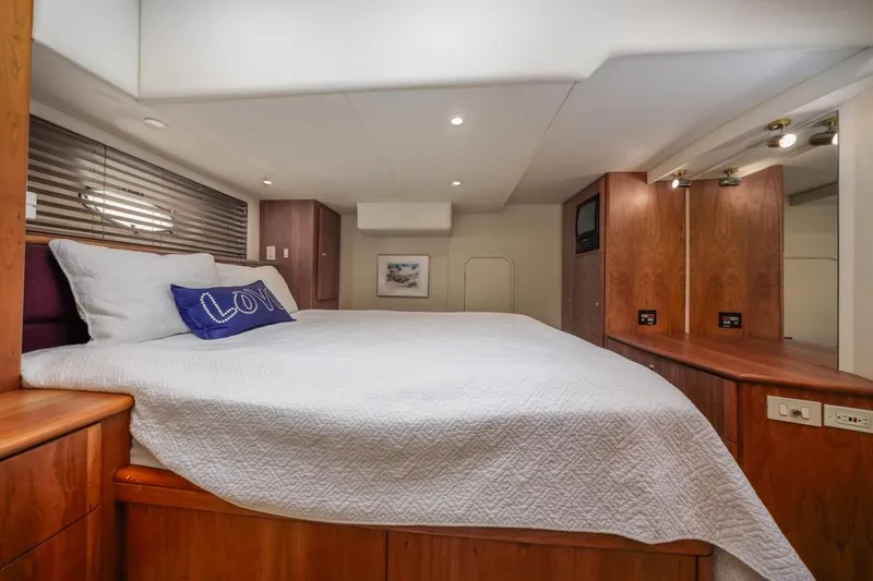 Just Joyce Yacht Photos Pics Luxurious bedroom interior of 2000 Silverton 435 yacht with cozy bedding and wooden accents.